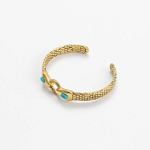 Gold snake-textured open cuff bracelet featuring light blue cabochon stones on white background