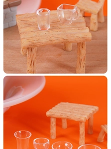 Macro detail of miniature dollhouse furniture with resin wood tables and clear plastic cups