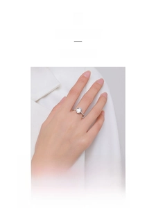 Macro shot of silver ring with oval-cut zircon and side diamond accents for women