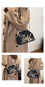 Detail of bamboo embroidery and gold metal frame on a black vintage Chinese handbag
