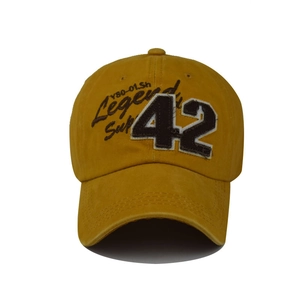 Detail of yellow washed cotton baseball cap with number 42 embroidery and legend text