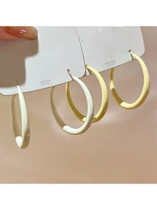 Detail view of cream and yellow hoop earrings with S925 silver needles on display card