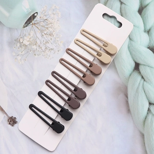 Set of 8 matte brown duckbill hair clips displayed on a card with knit yarn accents