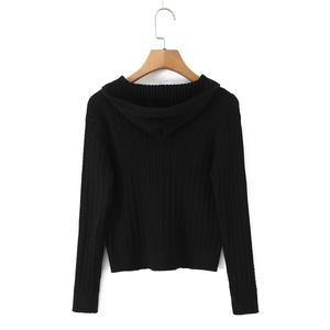Detailed close-up of vertical cable knit texture on black hooded zip cardigan