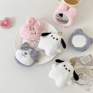 Cute plush animal handheld mirrors and keychains collection on a clean white desk