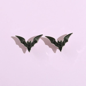 Punk style black bat metal badge with silver edges on a minimal lavender background