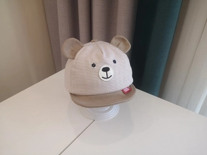Detailed view of baby striped sun hat with 3D bear ears and cute facial embroidery