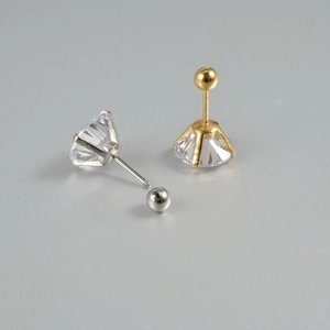 Detail view of gold and silver stud earrings with 6-prong set cubic zirconia and screw backs