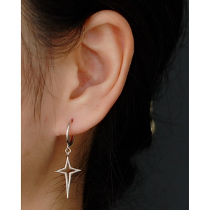 Close-up of minimalist S925 sterling silver hoop earrings with North Star charm on model