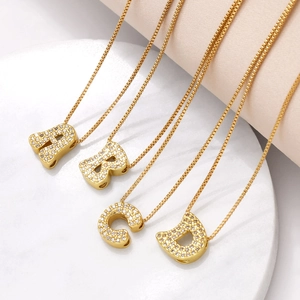 Detailed view of gold plated initial necklaces A B C D with shimmering zircon crystals