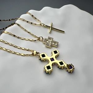 Three-layered gold cross necklace set with minimalist zircon and colored gemstone pendants