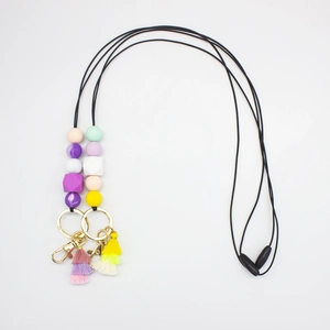 Detail of colorful silicone bead lanyard with cotton tassels and gold metal lobster clasps