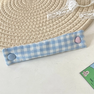 Blue and white plaid fabric cable organizer featuring cute heart and round button details