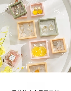 Pastel PE film suspension jewelry boxes for rings and necklaces on a white table