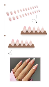 Détails de faux ongles roses en amande avec motifs floraux et fleurs blanches