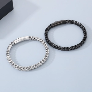 Close-up of black and silver stainless steel dragon bone chain bracelets with secure clasps