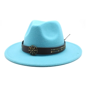 Detail of bright blue wool fedora featuring brown leather band and bronze floral studs