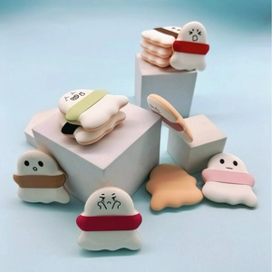 Cute cartoon character air cushion makeup puffs with colorful ribbons on white display