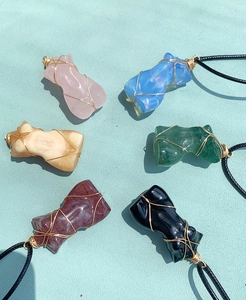 Detailed collection of crystal female torso pendants wrapped in gold wire with cords