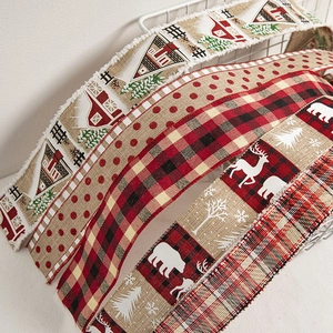 Assorted Christmas ribbons with plaid and elk patterns for festive gift wrapping