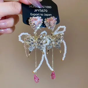 Sparkling butterfly earrings with pink heart crystal and elegant pearl tassels