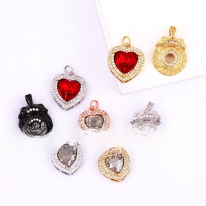 Detailed view of copper gold-plated heart and snowflake charms with zircon inlays