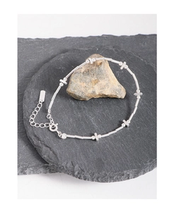 Detail view of S925 sterling silver beaded bracelet with cross star charm and tube accents