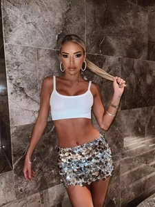 Chic two-piece set with a white crop top and a shimmering silver sequin mini skirt