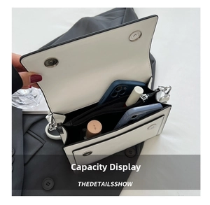 Detail of white leather crossbody bag interior showing spacious two-phone capacity
