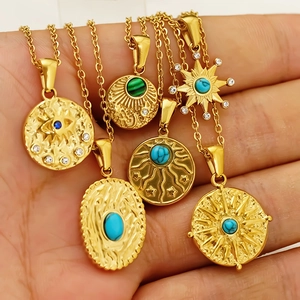 Retro turquoise and titanium steel pendants featuring sun and evil eye designs in gold
