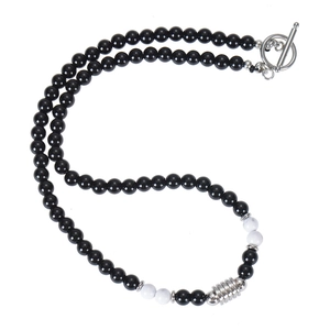 Detail of 6mm tiger eye and obsidian beaded necklace with silver toggle clasp closure