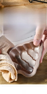 Primo piano dello stampo per torte in silicone a forma di albero di Natale dorato.