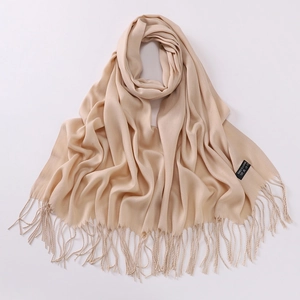 Detail shot of beige 100% cashmere scarf featuring soft texture and elegant fringe edges