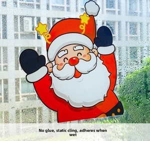 Close-up of Santa Claus static window sticker applying to glass with water droplets