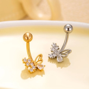 Close-up of gold and silver butterfly belly rings with sparkling cubic zirconia stones