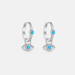 Detailed macro of S925 sterling silver evil eye earrings with blue zircon stones