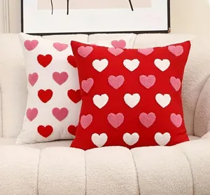 Close-up of 3D tufted heart embroidery on red and white cotton decorative pillowcases