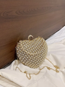 Sparkling heart-shaped evening bag with white rhinestones and golden chain strap