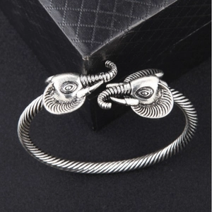 Vintage silver open bangle for men featuring dual elephant heads and twisted metal design