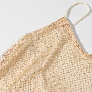 Detail of beige mesh halter dress with sparkling silver sequins and delicate texture
