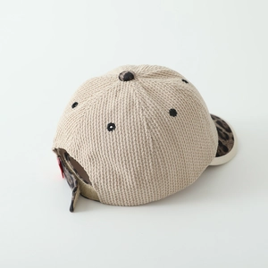 Detail view of adjustable leopard print back strap and beige corduroy on baseball cap