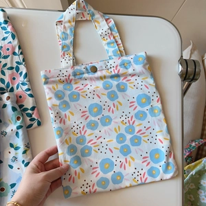 Detail of floral cotton tote bag featuring vintage gold metal buckle and neat stitching