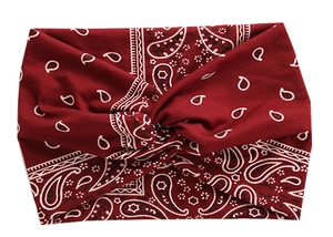 Detail of burgundy paisley wide headband showing twisted knot and soft elastic fabric