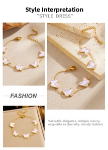 Detail of a gold butterfly bracelet with white wings and adjustable lobster clasp