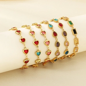 Detailed view of seven gold bracelets with colorful heart and square crystal stones