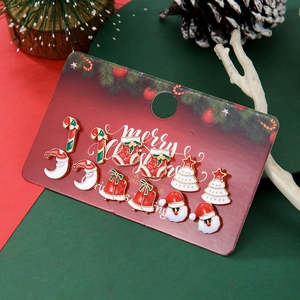 Detail view of a 6-pair Christmas stud earring set featuring Santa and bells on card
