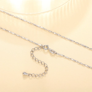 Detailed close-up of a silver water wave chain with lobster clasp and extension link