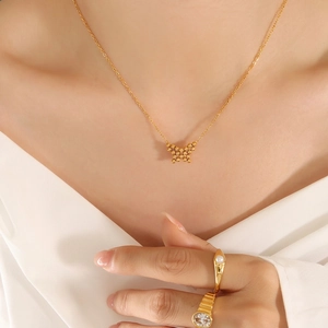 Gold butterfly pendant necklace and elegant pearl ring set for women on model