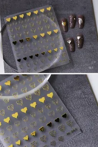 Macro view of M-069 gold heart nail stickers with black heart and hollow designs