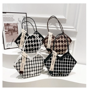Close-up of four stylish large tote bags with tweed and quilted textures on white pedestals